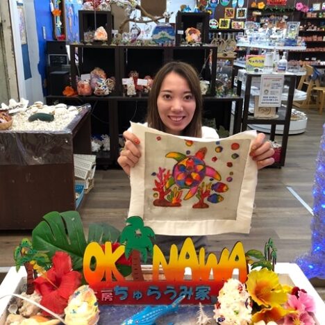 紅型染めした壁掛けと女性