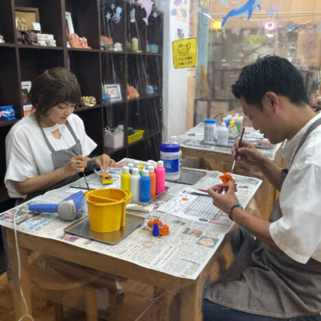 シーサーの絵付けをしている夫婦
